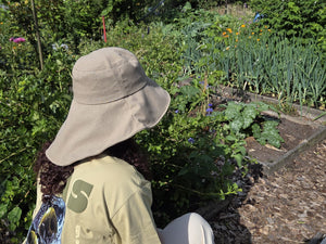 Stay cool while tending your garden with this elegant linen wide brim sun hat. Made from breathable linen, with a full face and neck coverage, perfect for sunny days among your veggies and flowers, or simply enjoying your garden. The adjustable chin strap keeps it secure on breezy afternoons, making it your ideal companion for every garden adventure.