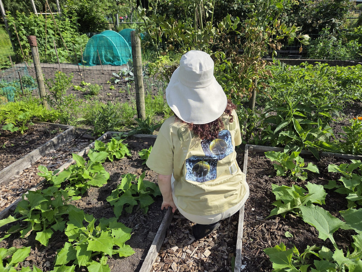 Stay cool while tending your garden with this elegant linen wide brim sun hat. Made from breathable linen, with a full face and neck coverage, perfect for sunny days among your veggies and flowers, or simply enjoying your garden. The adjustable chin strap keeps it secure on breezy afternoons, making it your ideal companion for every garden adventure." Available in beige and camel