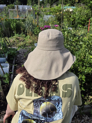 Stay cool while tending your garden with this elegant linen wide brim sun hat. Made from breathable linen, with a full face and neck coverage, perfect for sunny days among your veggies and flowers, or simply enjoying your garden. The adjustable chin strap keeps it secure on breezy afternoons, making it your ideal companion for every garden adventure.